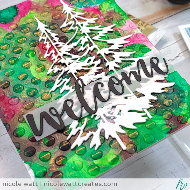 greeting card featuring Playful Circles embossing folder by Altenew, Woodlands dies by Tim Holtz, Prima Metallique wax, and Liquitex acrylics, by Nicole Watt - Nicole Watt Creates (nicolewattcreates.com)